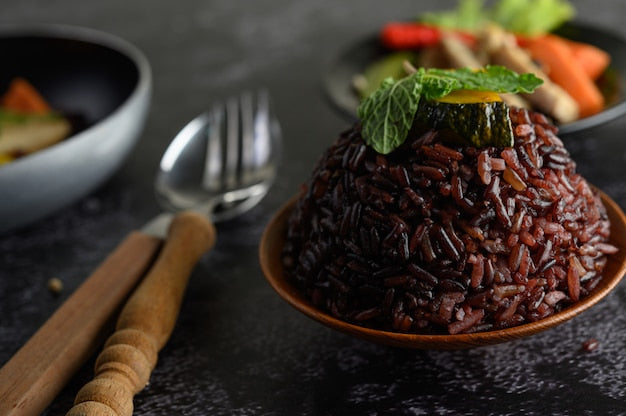 A vibrant salad made with organic black rice, vegetables, and herbs.